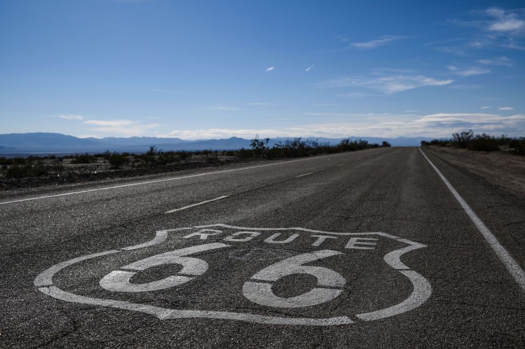 A "Route 66" sign is painted on the asphalt near Amboy in the Mojave Desert in California. Maybe soon to be unregulated by a speed limit