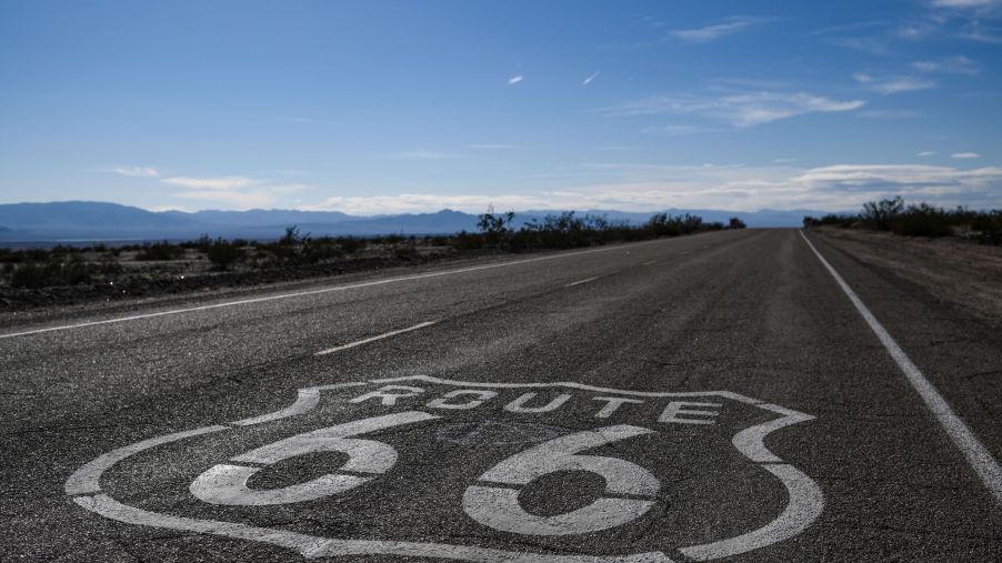 A "Route 66" sign is painted on the asphalt near Amboy in the Mojave Desert in California