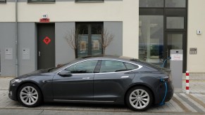 A Tesla Model S electric car charges at a public charging column on March 2, 2019, in Berlin, Germany.