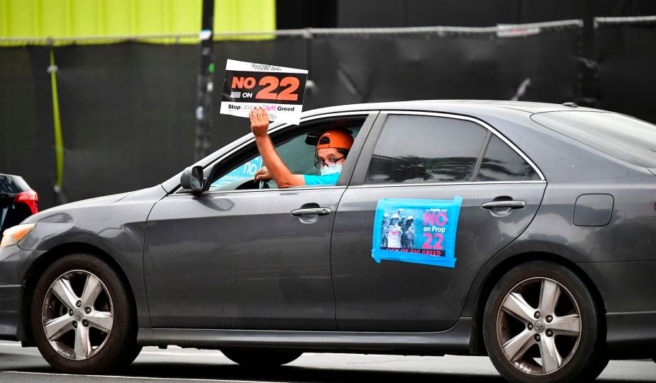 App-based drivers from Uber and Lyft protest in a caravan in front of City Hall in Los Angeles on October 22, 2020.