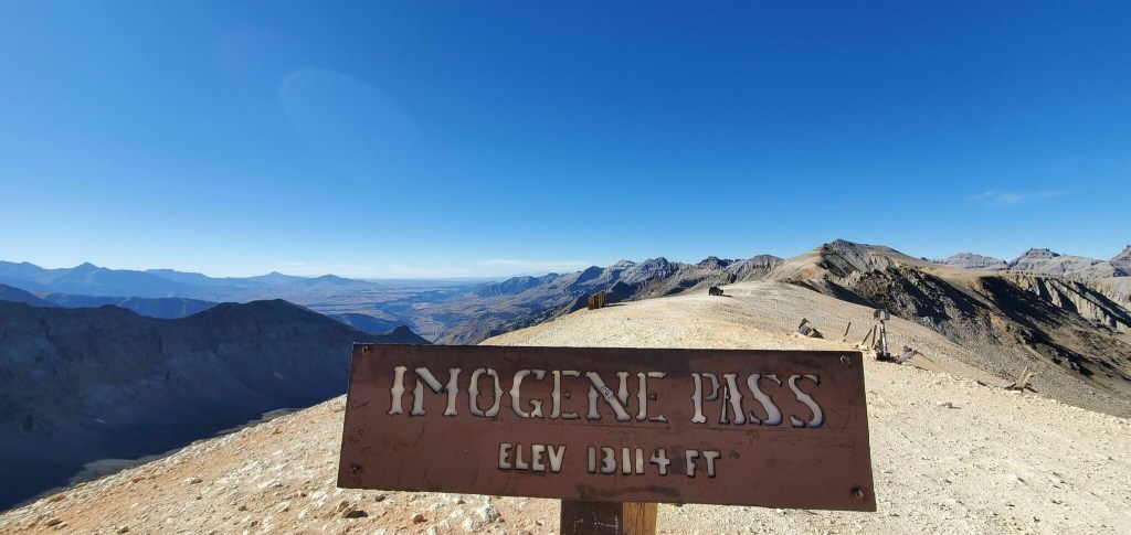 Imogene Pass highest elevation point sign with a mountain view in the background of this pretty off-road trail
