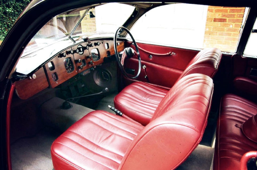 The red leather seats and wood dashboard of a 1953 Bristol 403