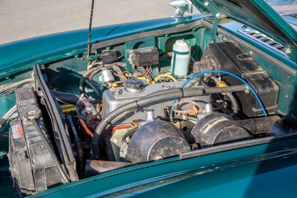 A turquoise 1965 MG MGB's engine bay