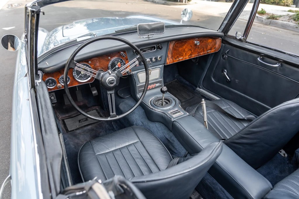 The blue-leather front seats and walnut dashboard of a 1967 Austin-Healey 3000 Mk3 BJ8
