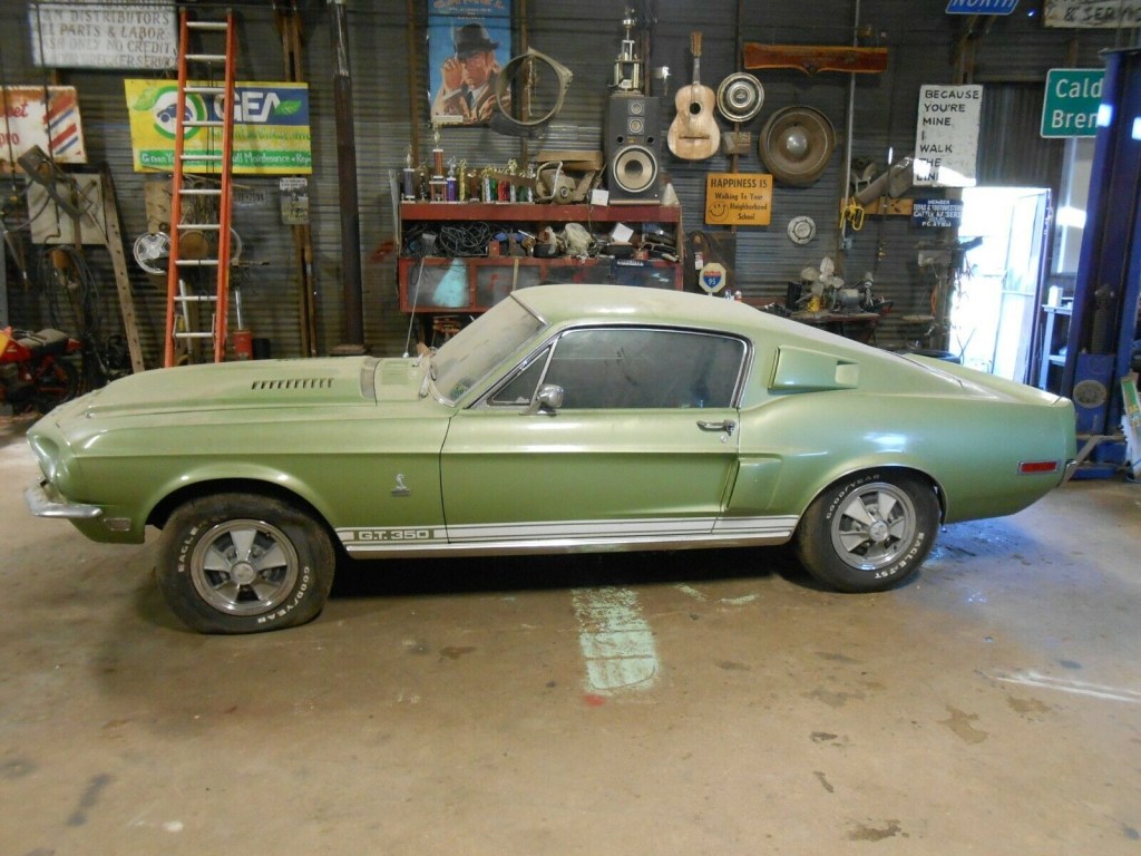 Driver's side profile view of a lime green 1968 Shelby GT350 