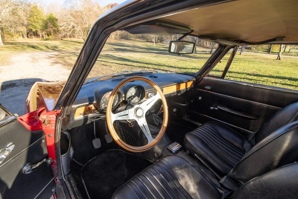 The 1971 Alfa Romeo GT 1300 Junior's black-leather front seats and wooden dashboard
