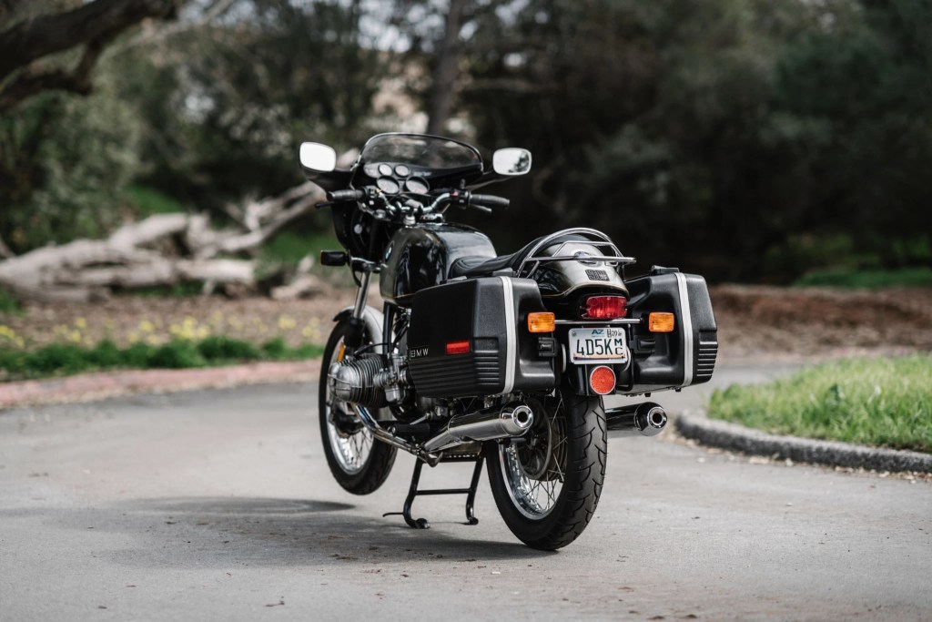 The rear 3/4 view of a black-and-gray 1975 BMW R90S with luggage