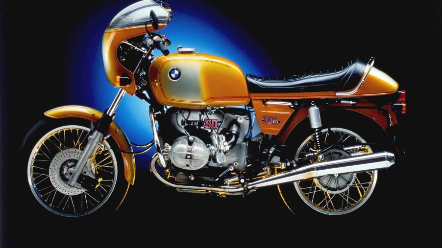 The side view of an orange-and-white 1975 BMW R90S