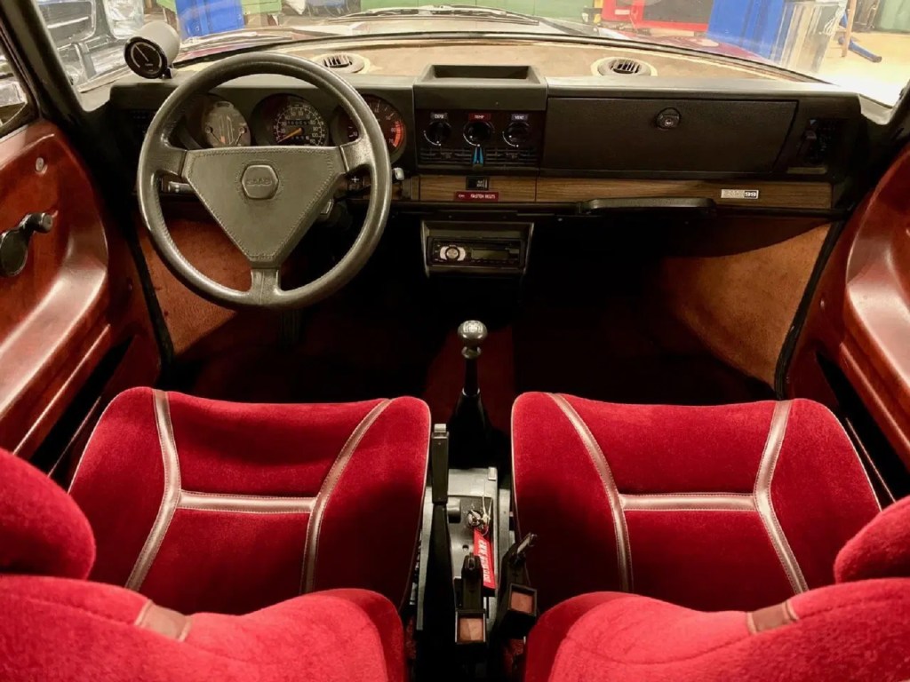 The 1978 Saab 99 Turbo's red velour front seats and wood dashboard