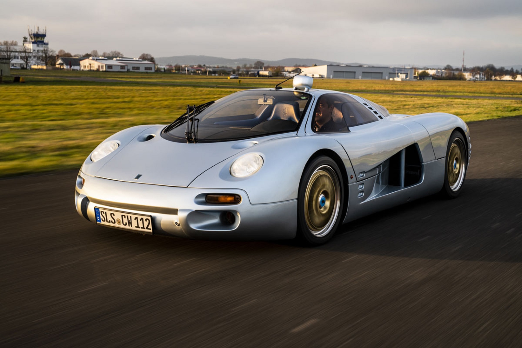 The silver 1993 Isdera Commendatore 112i on a track