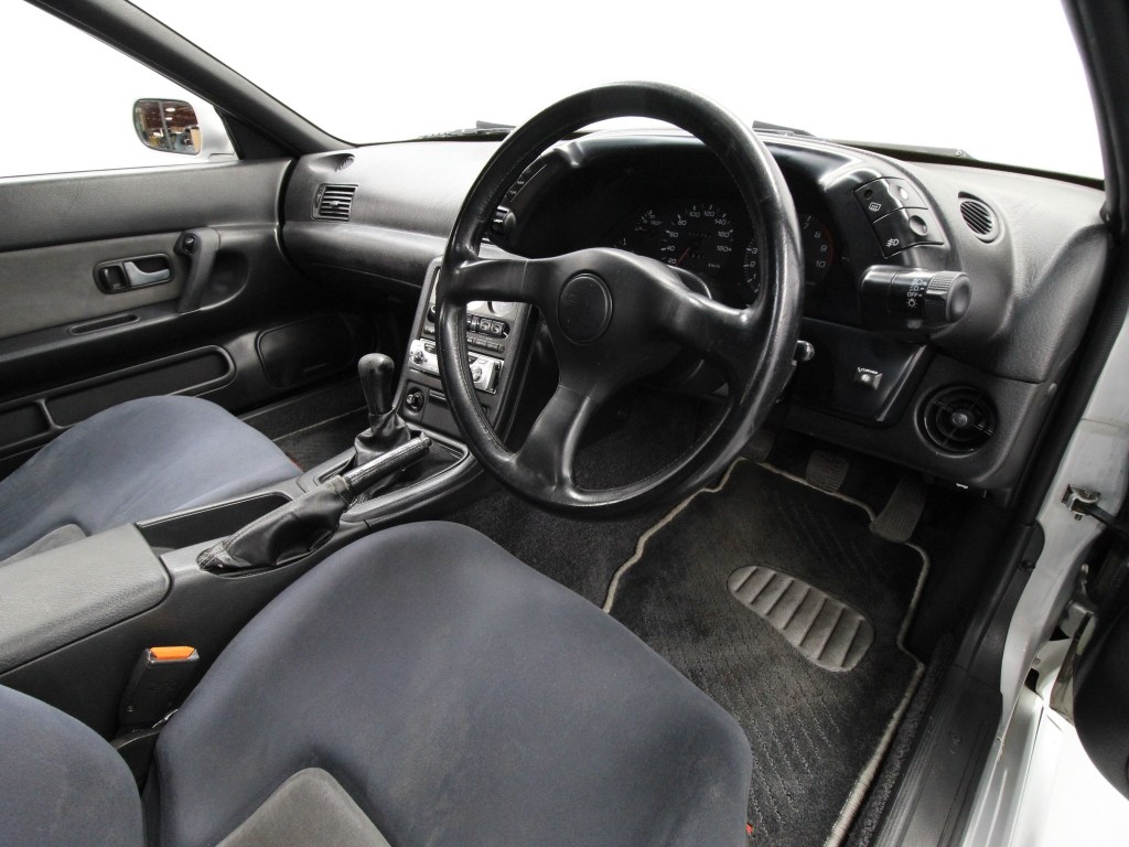 The 1994 Nissan R32 Skyline GT-R's front seats and black dashboard