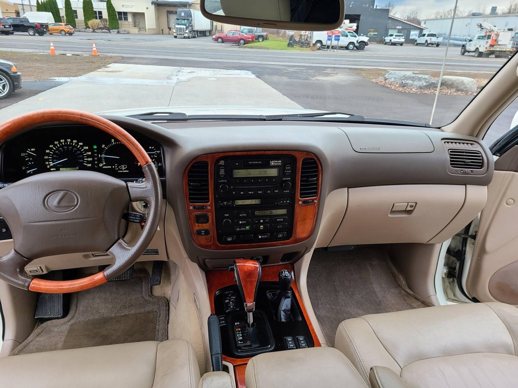 The 2000 Lexus LX 470's tan leather front seats and dashboard