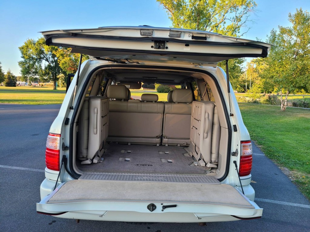 The 2000 Lexus LX 470's 3rd-row seats viewed from the open tailgates