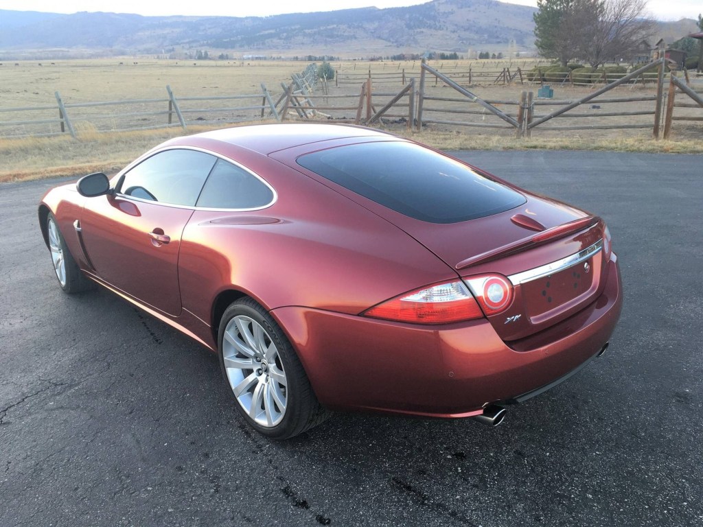 The rear 3/4 view of a red 2008 Jaguar XK coupe
