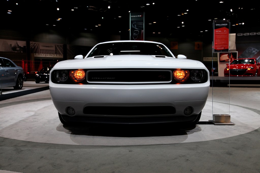 A Dodge Challenger on display at an auto show in 2013
