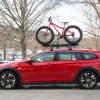 A red 2019 Buick Regal TourX carries a bicycle on its roof in Vermont during the winter