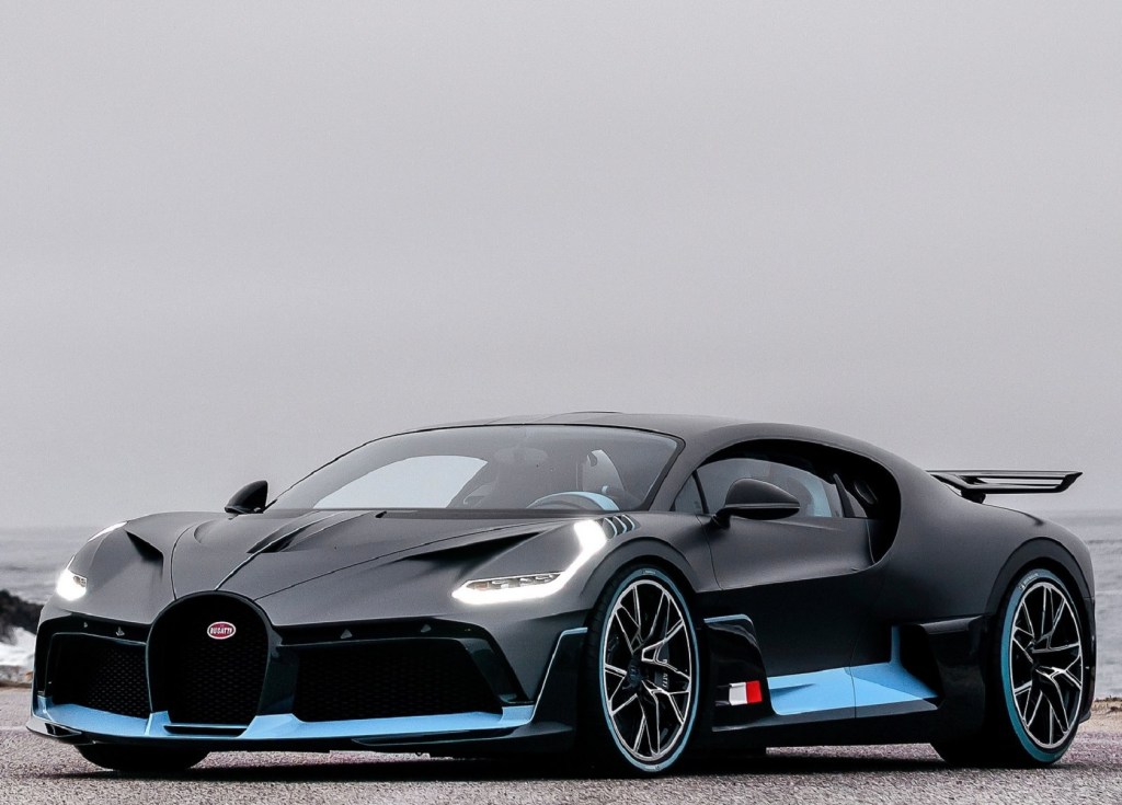 A black-and-blue 2020 Bugatti Divo by a beach