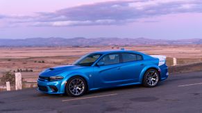 The side view of a blue-and-white 2020 Dodge Charger SRT Hellcat Widebody Daytona 50th Anniversary Edition