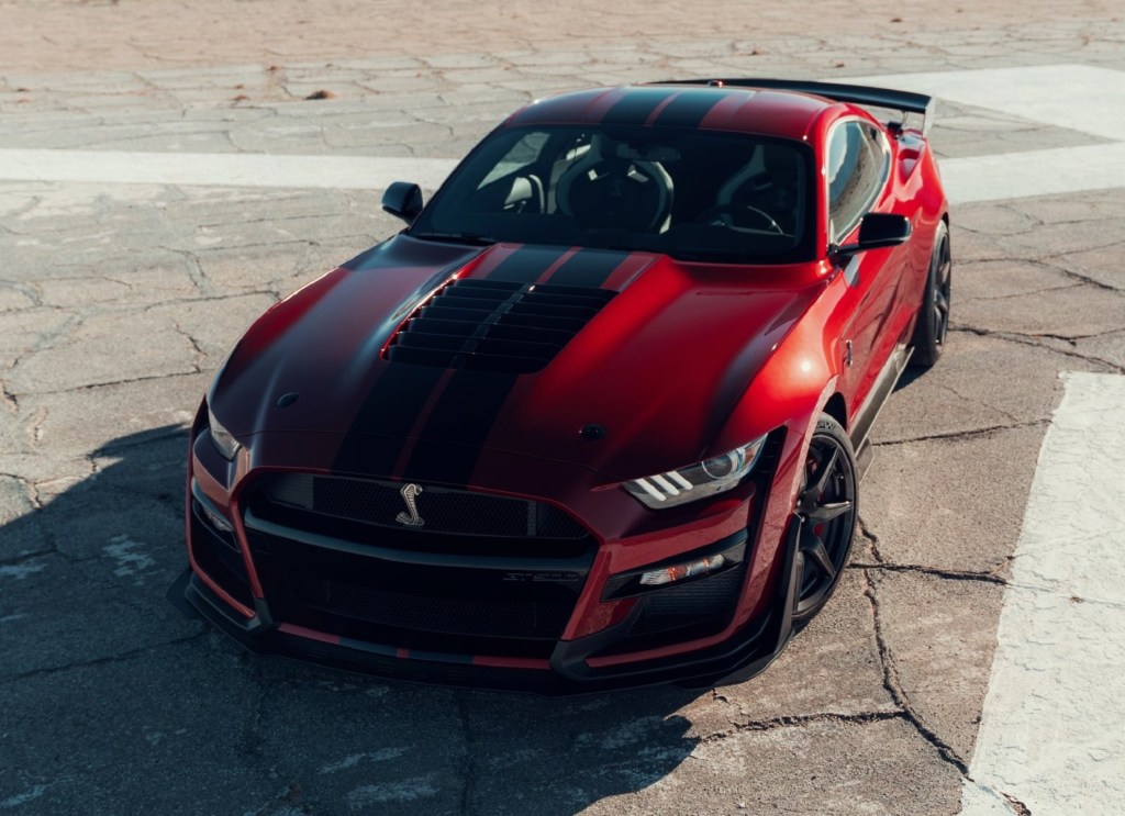 The front 3/4 view of a red-and-black 2020 Ford Mustang Shelby GT500
