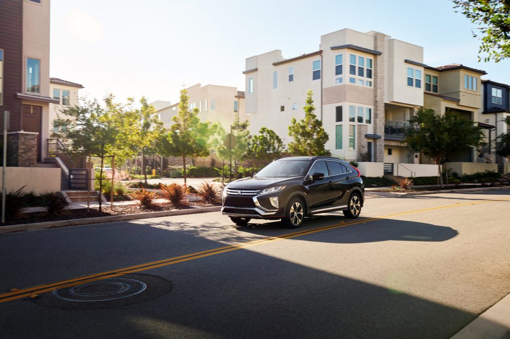 A black 2020 Mitsubishi Eclipse Cross driving down a city road
