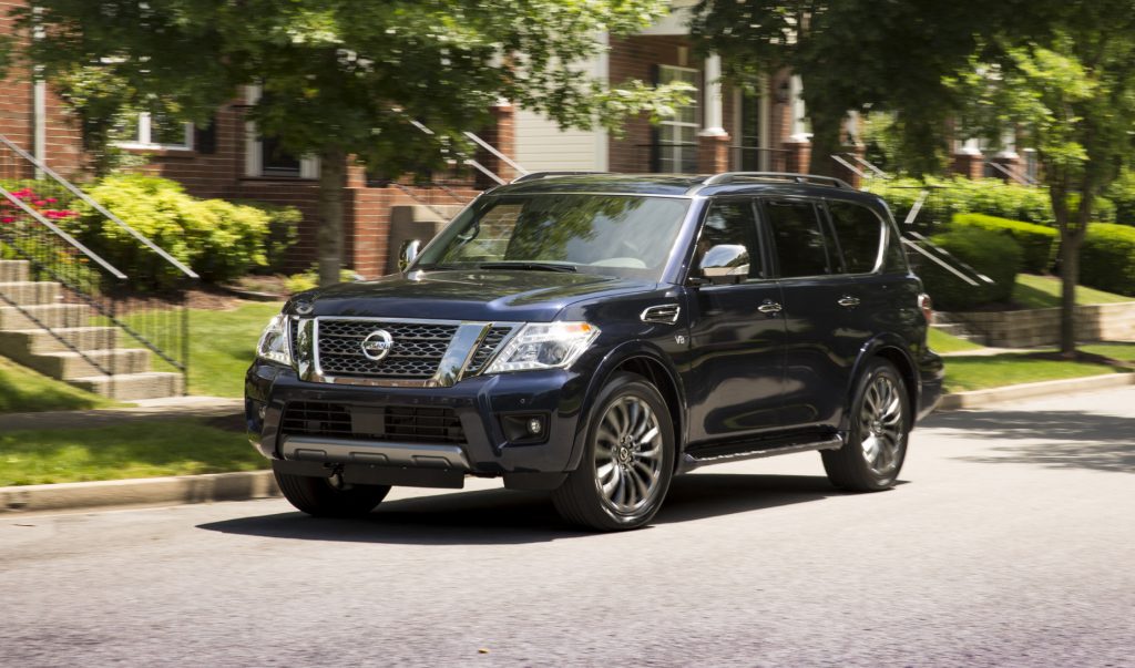A dark blue 2020 Nissan Armada driving down a city street