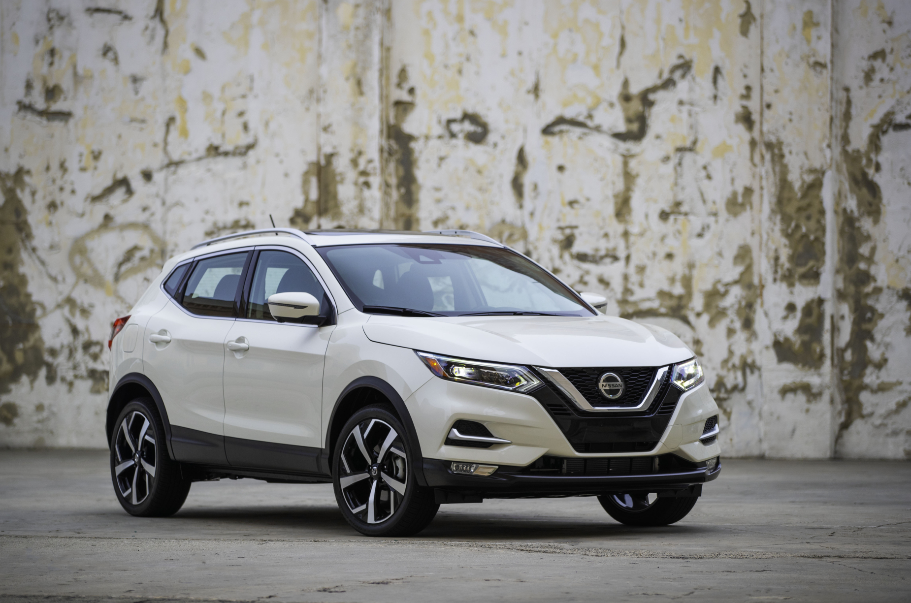 A white 2020 Nissan Rogue Sport on display next to a wall