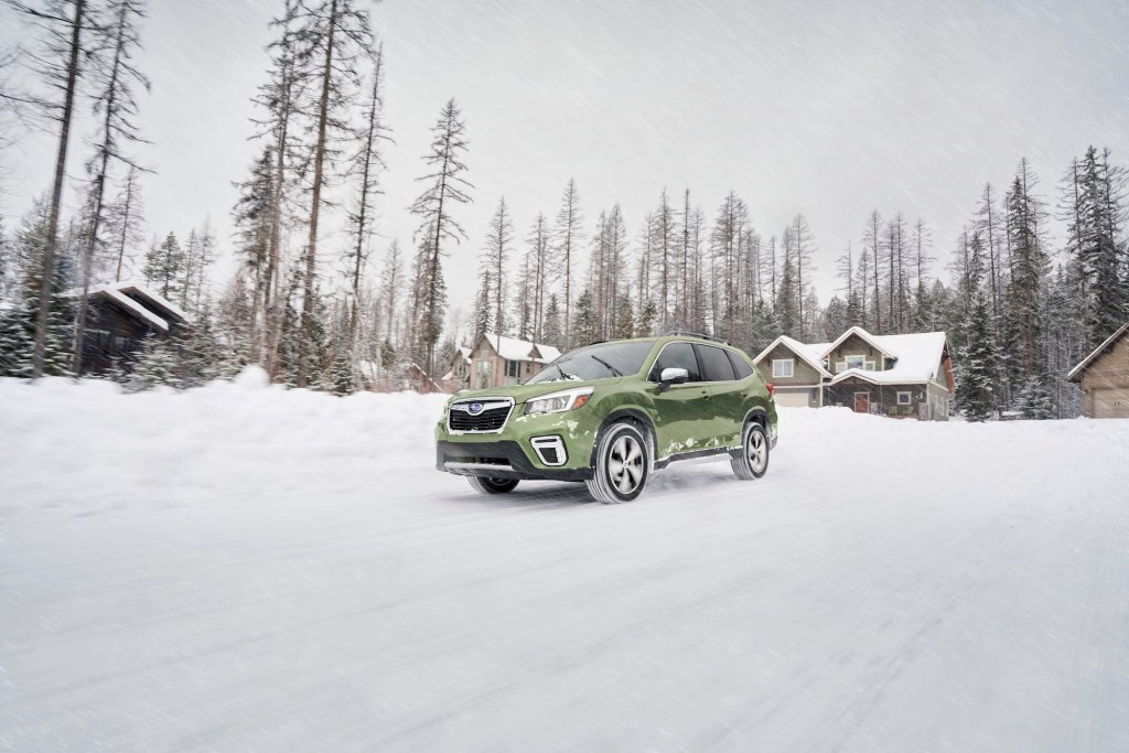 A 2020 Subaru Forester drives through the snow.