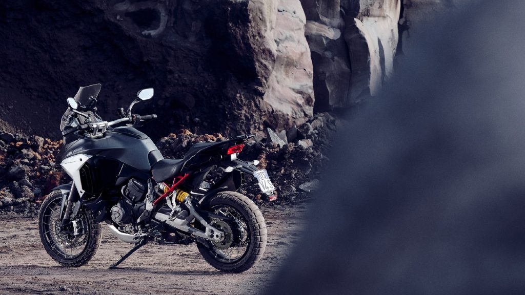 The rear 3/4 view of a silver 2021 Ducati Multistrada V4 S in a quarry