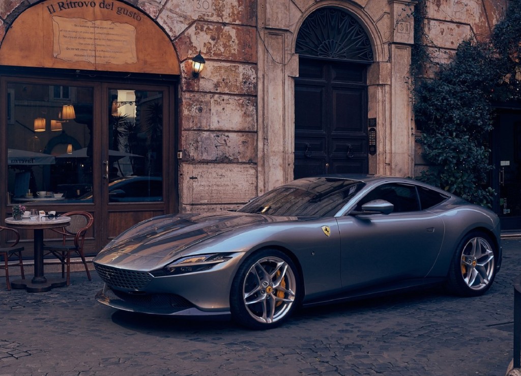 A gray 2021 Ferrari Roma by an Italian cafe