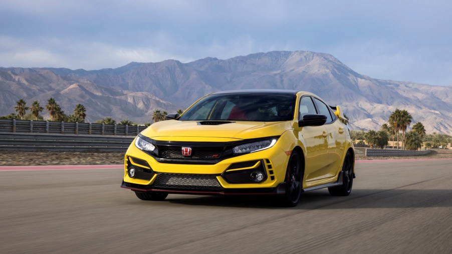 A yellow 2021 Honda Civic Type R Limited Edition driving in front of mountains