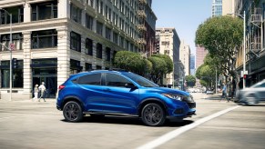 A blue 2021 Honda HR-V driving in the city
