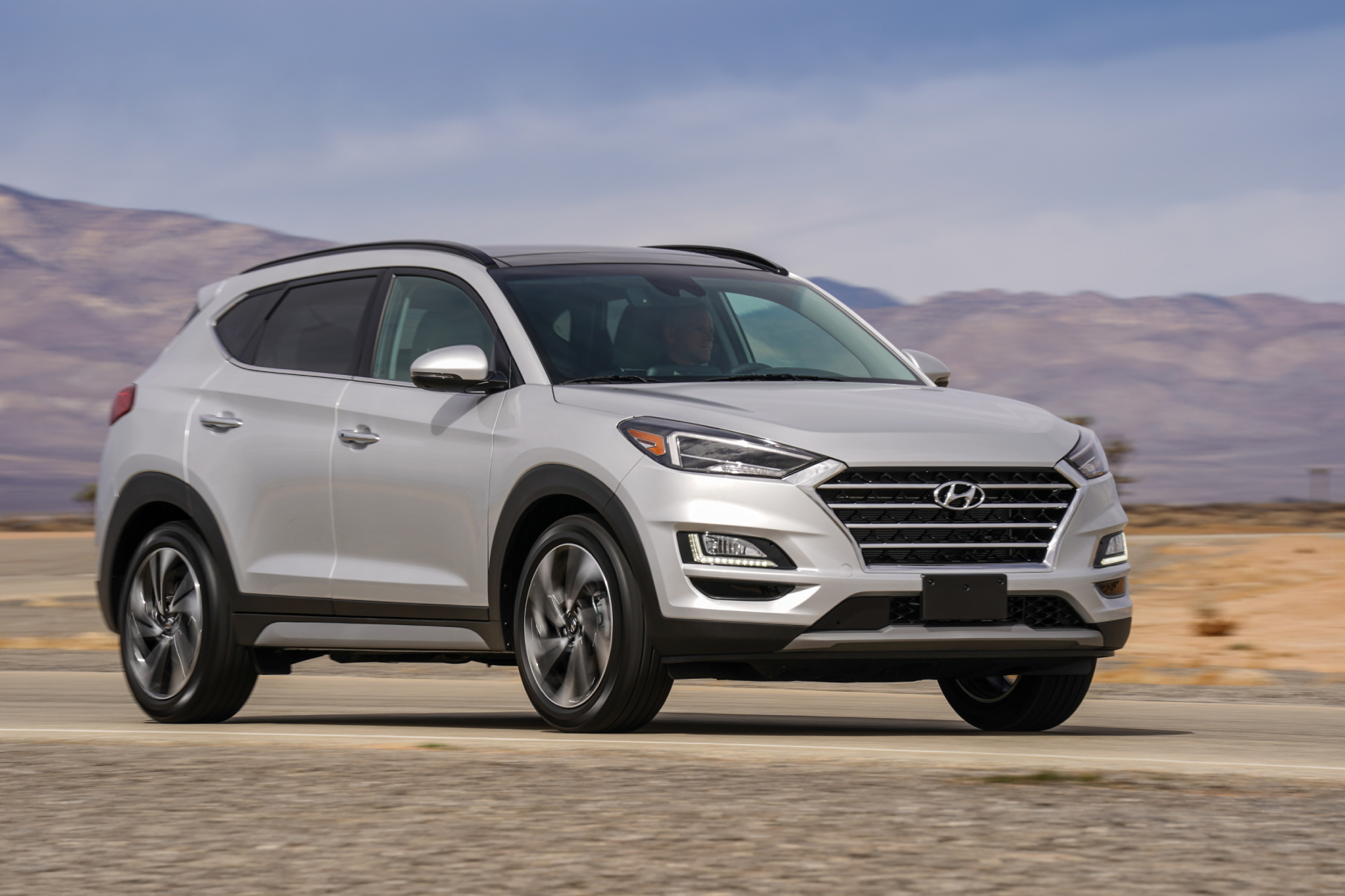 A silver 2021 Hyundai Tucson parked on display