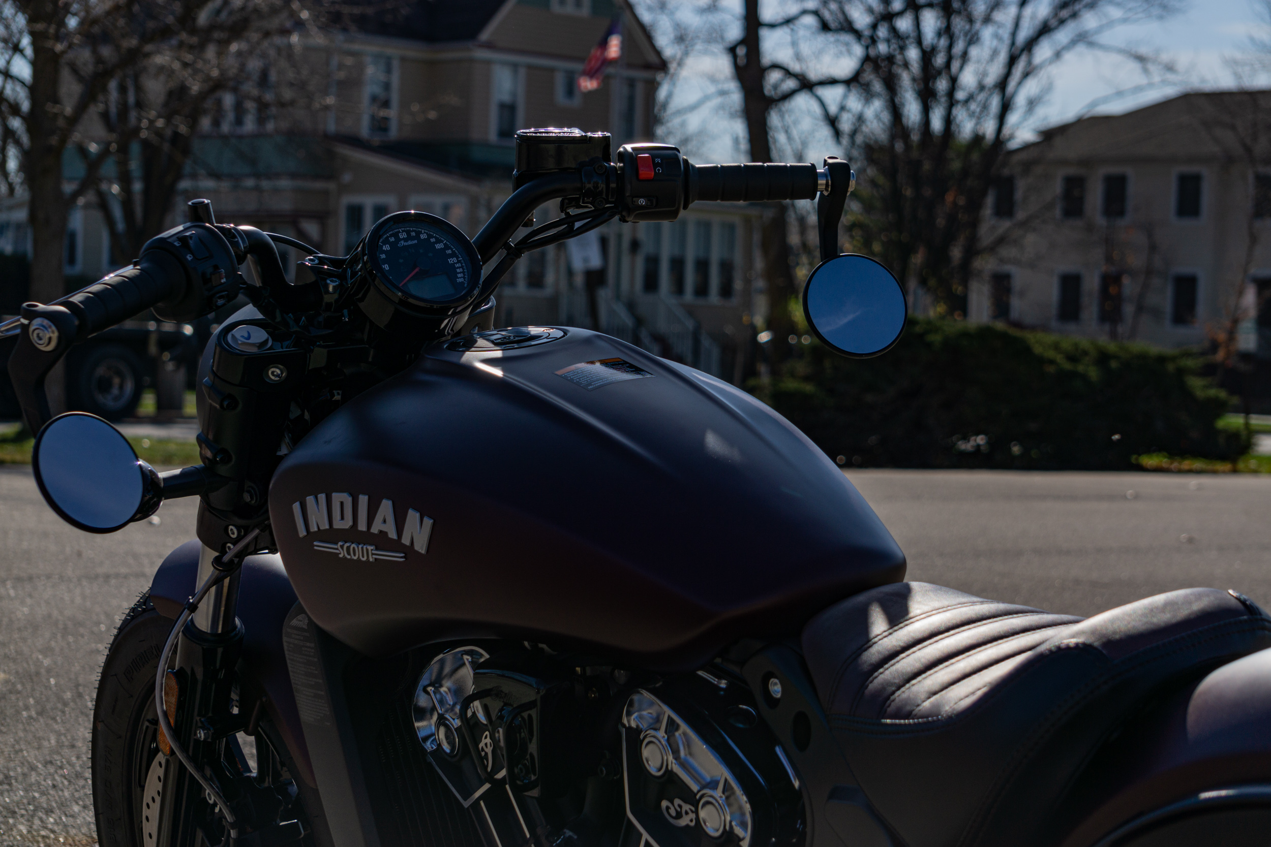 The rear 3/4 view of a 2021 Indian Scout Bobber motorcycle's handlebars and gauge