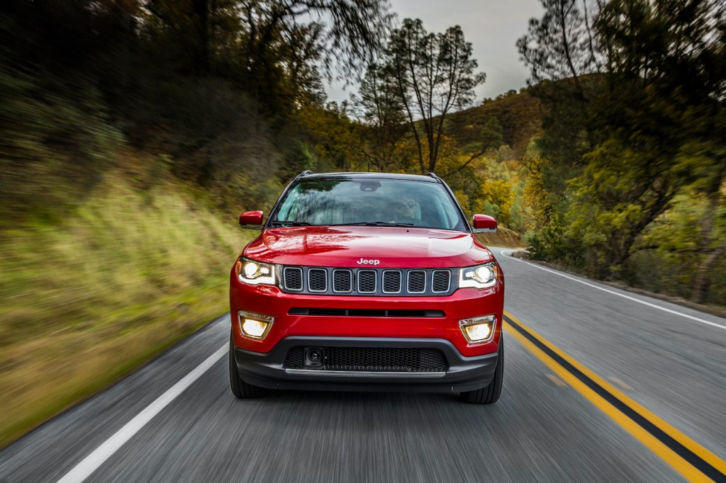 2021 Jeep Compass driving down an empty road