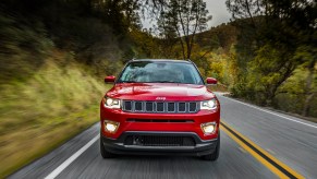 2021 Jeep Compass driving down an empty road