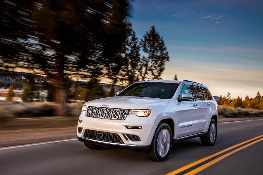 2021 Jeep Grand Cherokee Summit driving down the road