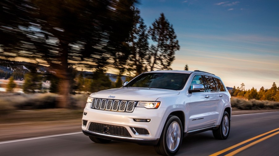 2021 Jeep Grand Cherokee Summit driving down the road