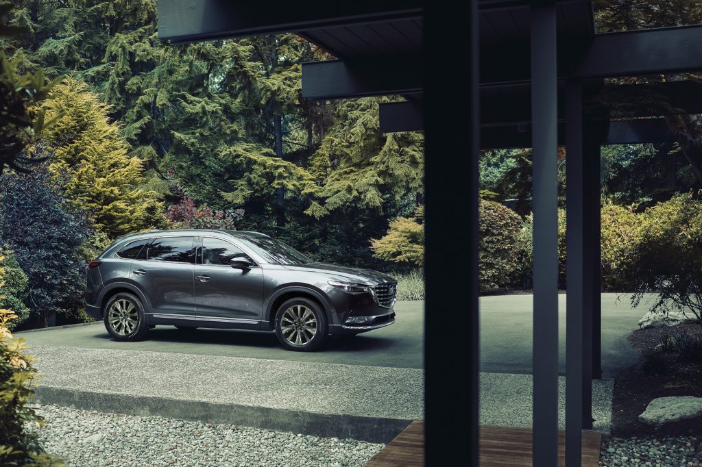 A silver 2021 Mazda CX-9 parked next to trees
