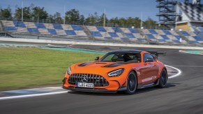 An orange 2021 Mercedes-AMG GT Black Series going around a corner on a race track