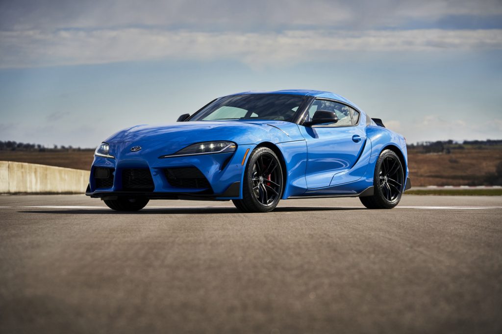 A bright-blue 2021 Toyota GR Supra A91 Edition is parked on a racetrack