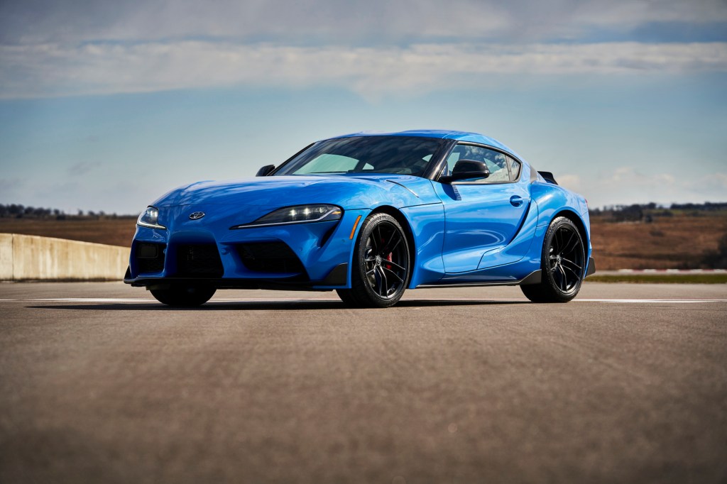 A bright-blue 2021 Toyota GR Supra A91 Edition is parked on a racetrack