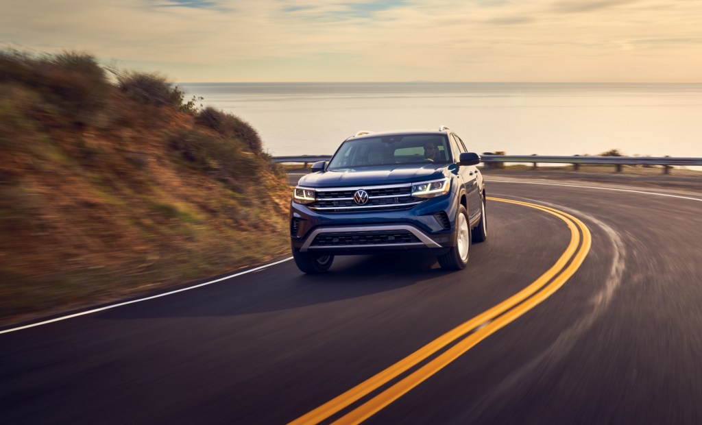 A blue 2021 Volkswagen Atlas driving down a highway road