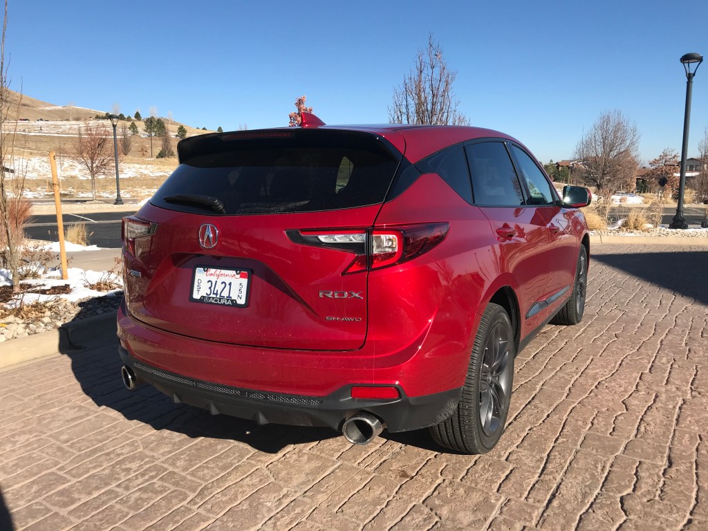 A red Acura RDX parked curbside.