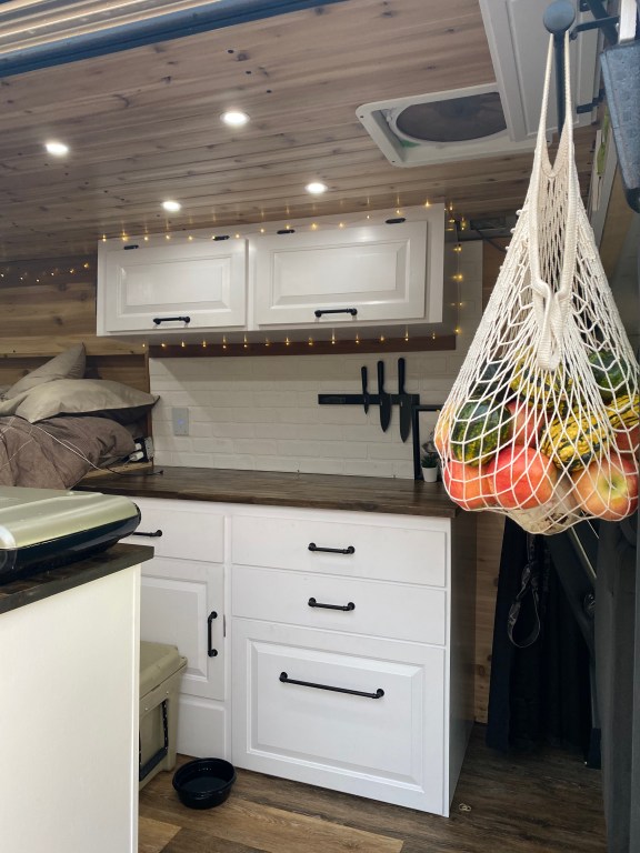 a view of the interior of the naked and afraid winner's camper van built out with elegance and utility