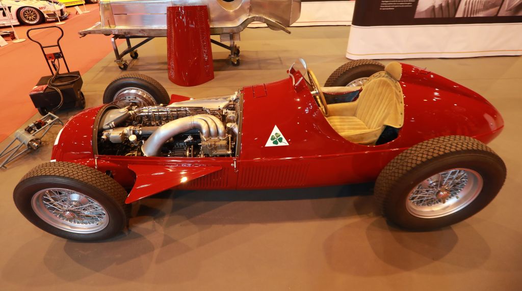 A red, center-drive, Alfa Romeo racecar from the 1930s