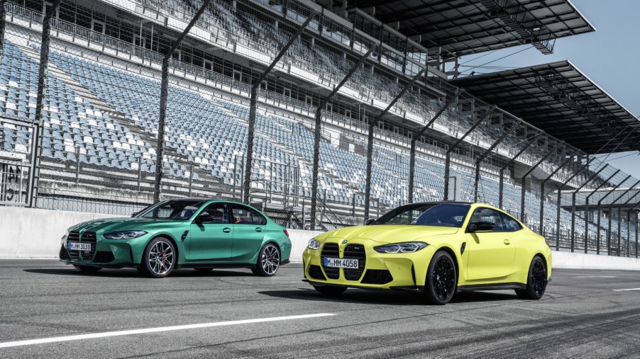 Green and yellow BMW M3 Competition models driving on a track