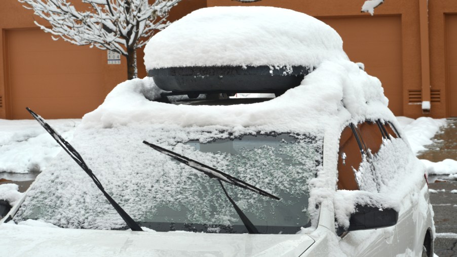 A car parked outside covered in snow