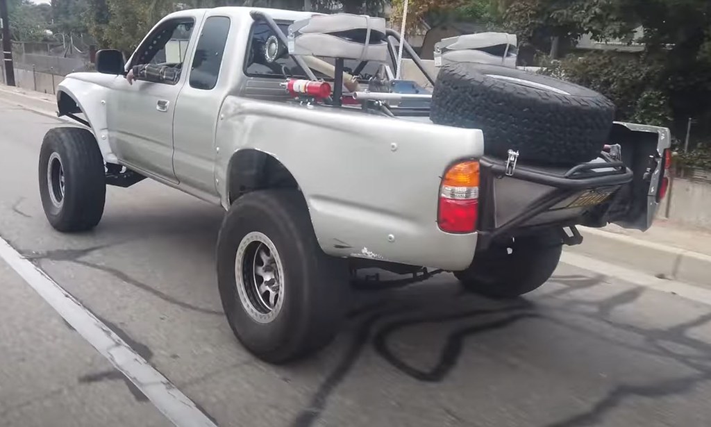 The rear of a silver custom 1999 Toyota Tacoma Baja Pre-Runner pickup truck.