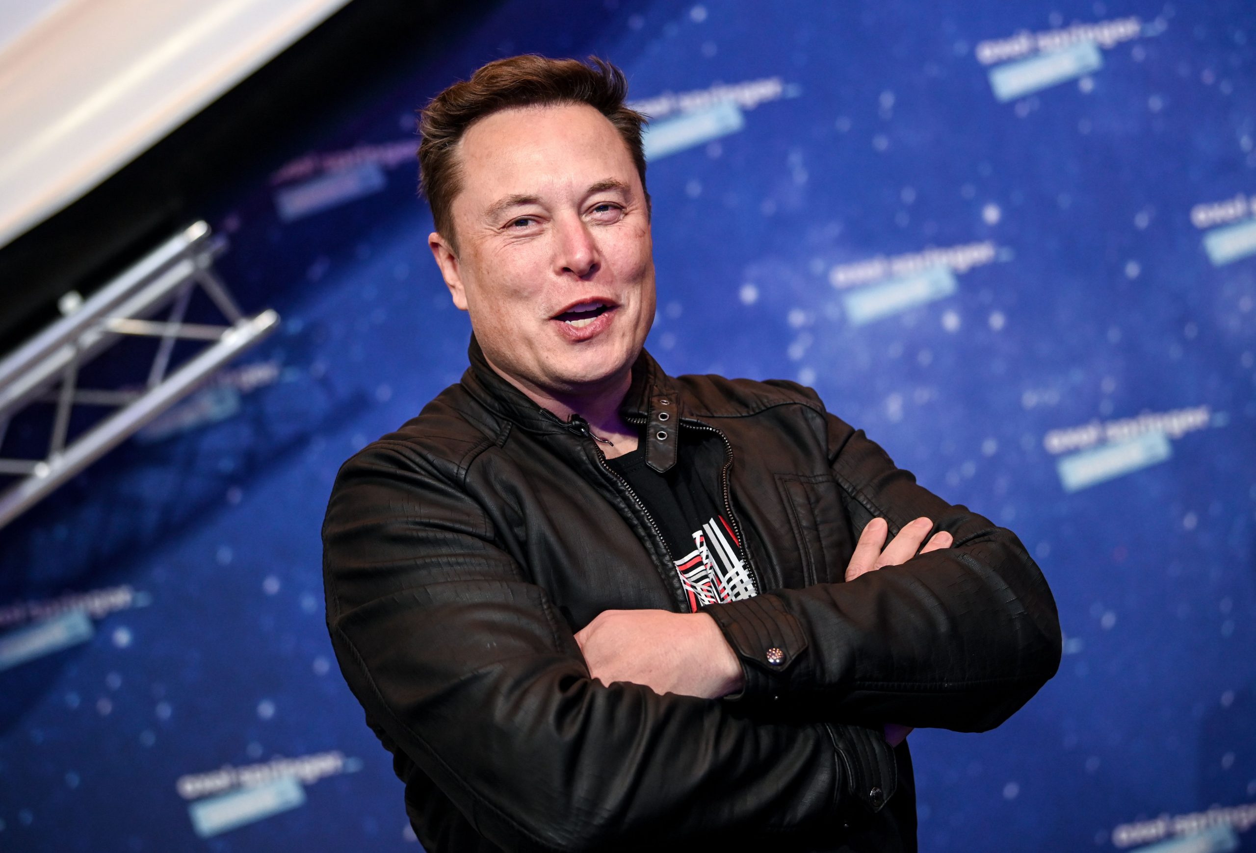 Elon Musk smiles for a photo on the red carpet