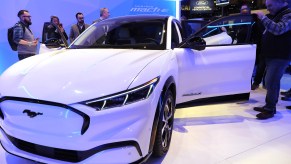 Attendees examine the Ford Mustang Mach-E all electric vehicle at the Chicago Auto Show at McCormick Place